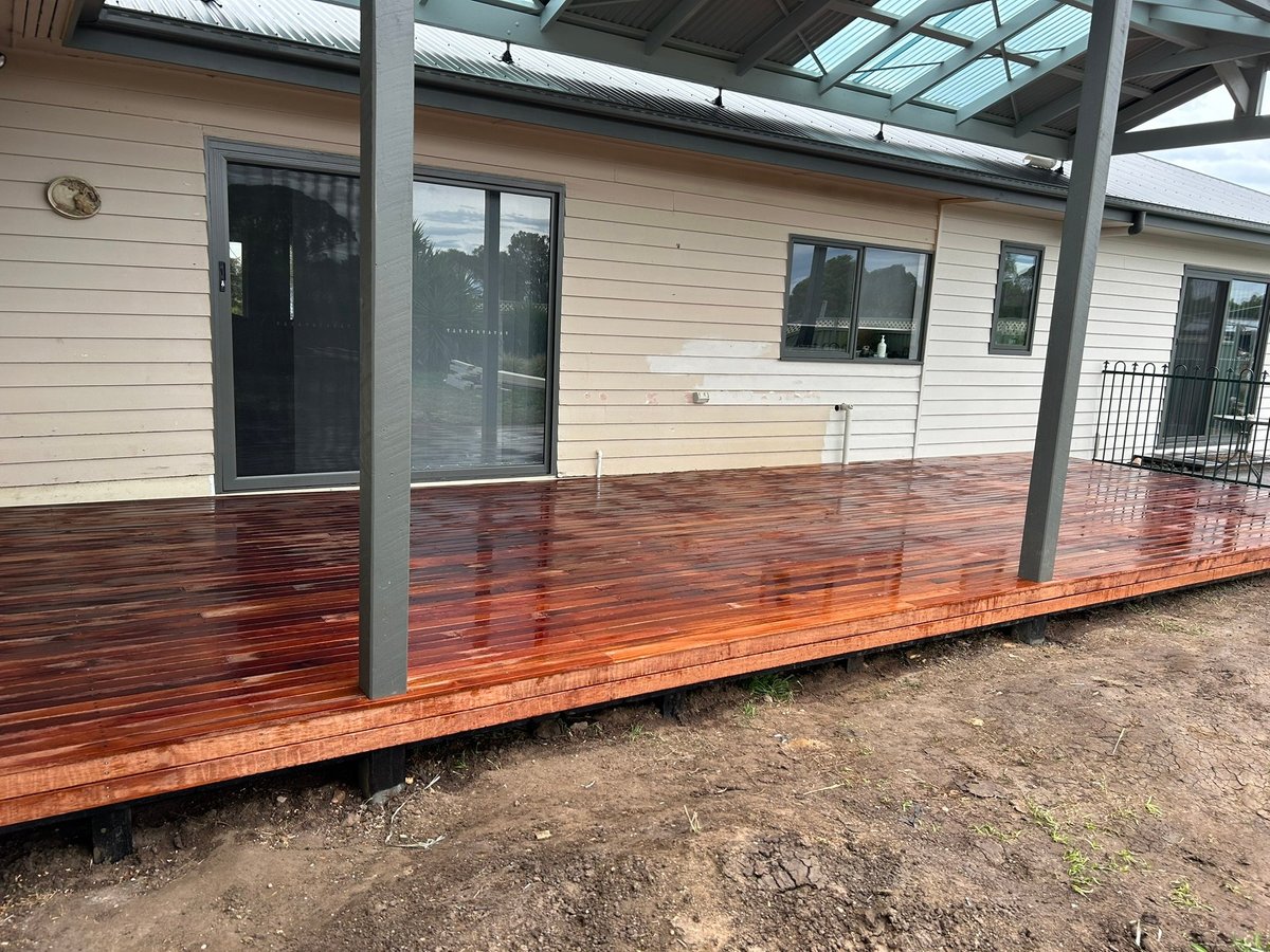 The finished covered deck and glass doors at the rear of the Newtown renovation