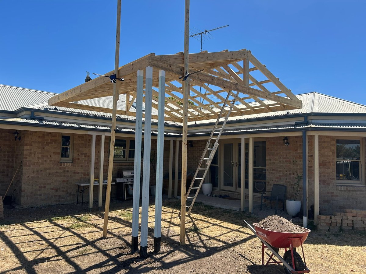 A carport under construction by Morrissey Built, showing the timber frame and brick home in Geelong