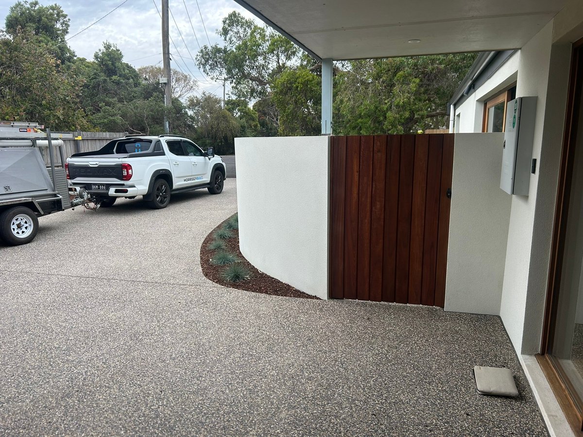 A completed Morrissey Built home in Geelong with a timber gate and gravel driveway